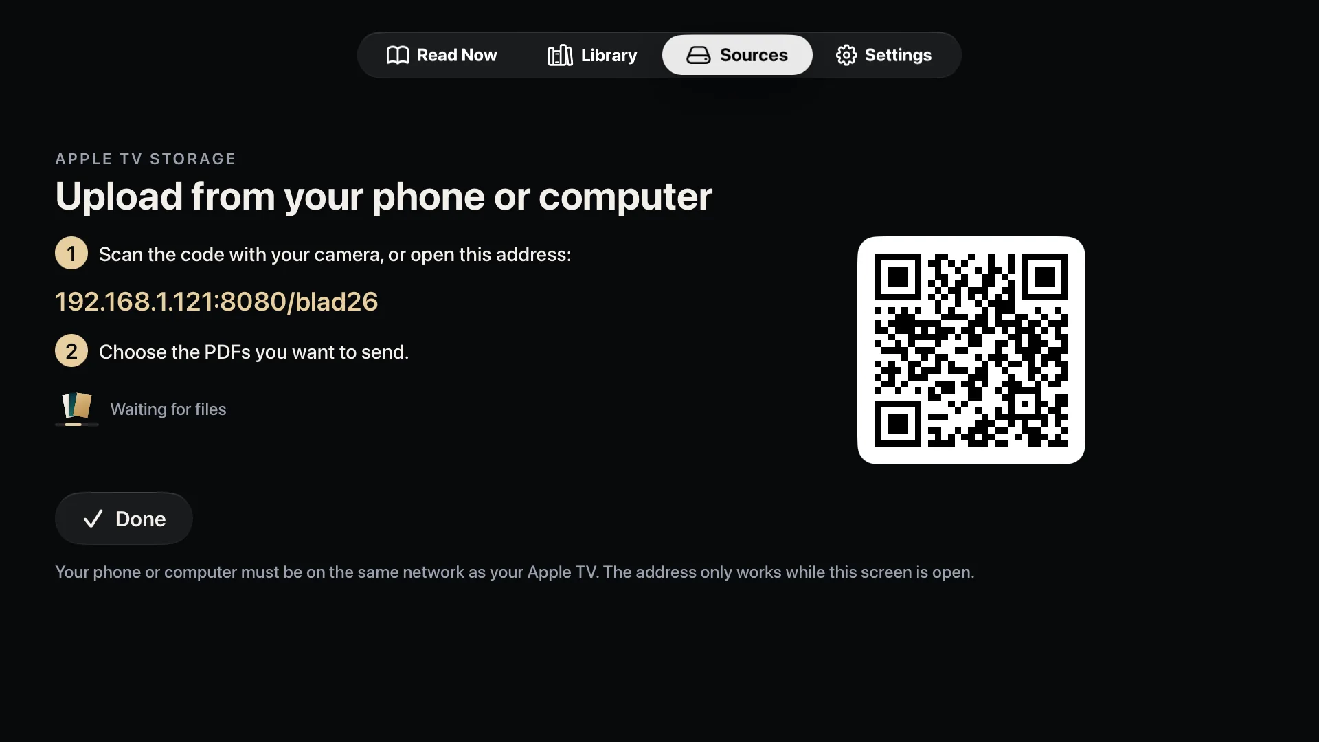The Apple TV showing a QR code and an address for sending files from a phone